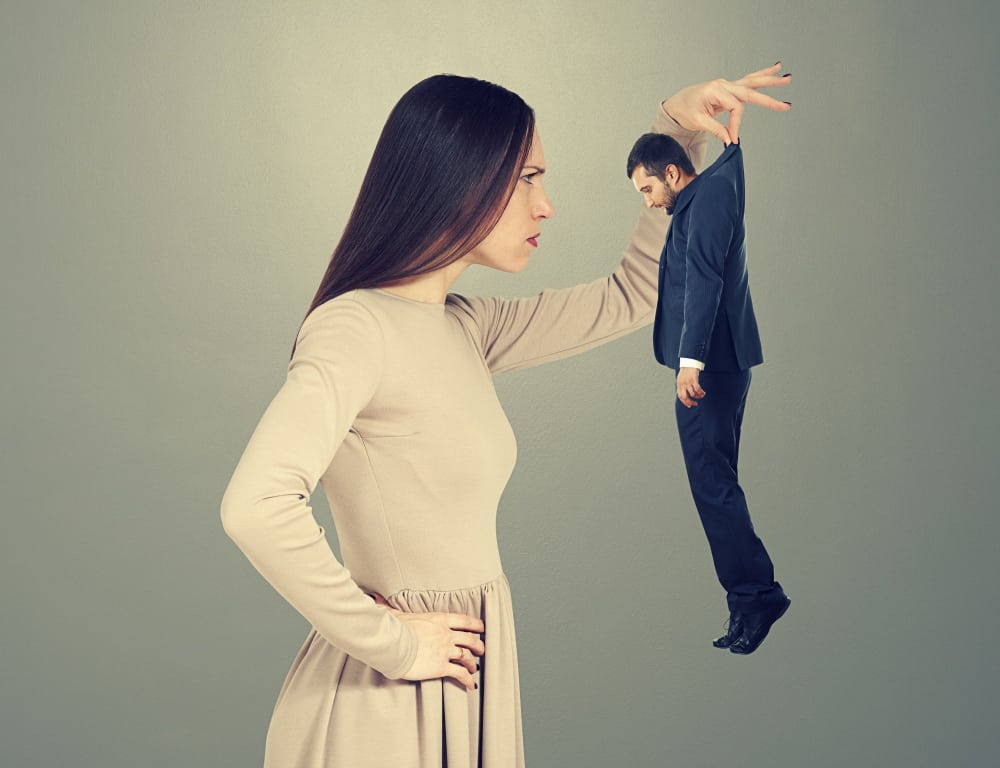 serious young woman looking at the short man