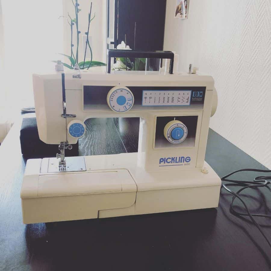 White sewing machine on a dark table