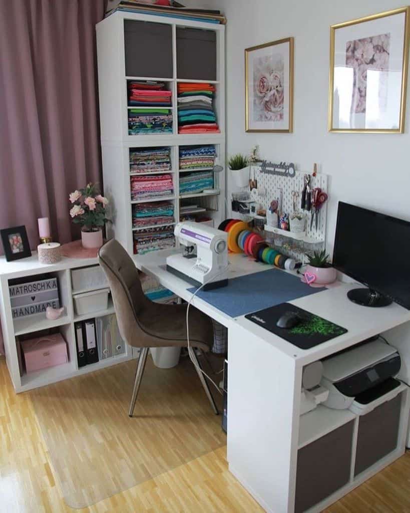 Modern sewing area with organized fabric shelves, a pegboard for tools, soft pink decor, and a functional workspace