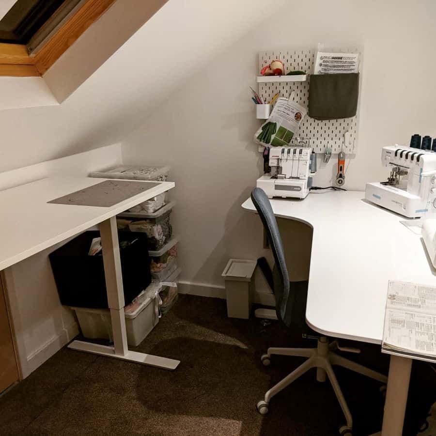 Compact sewing room with angled ceiling, ergonomic desk setup, and clear storage bins for organized supplies
