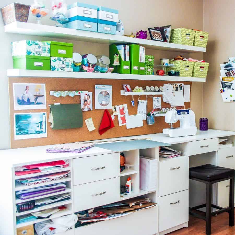 Colorful sewing station with storage shelves, a corkboard for inspiration, and a compact sewing desk setup