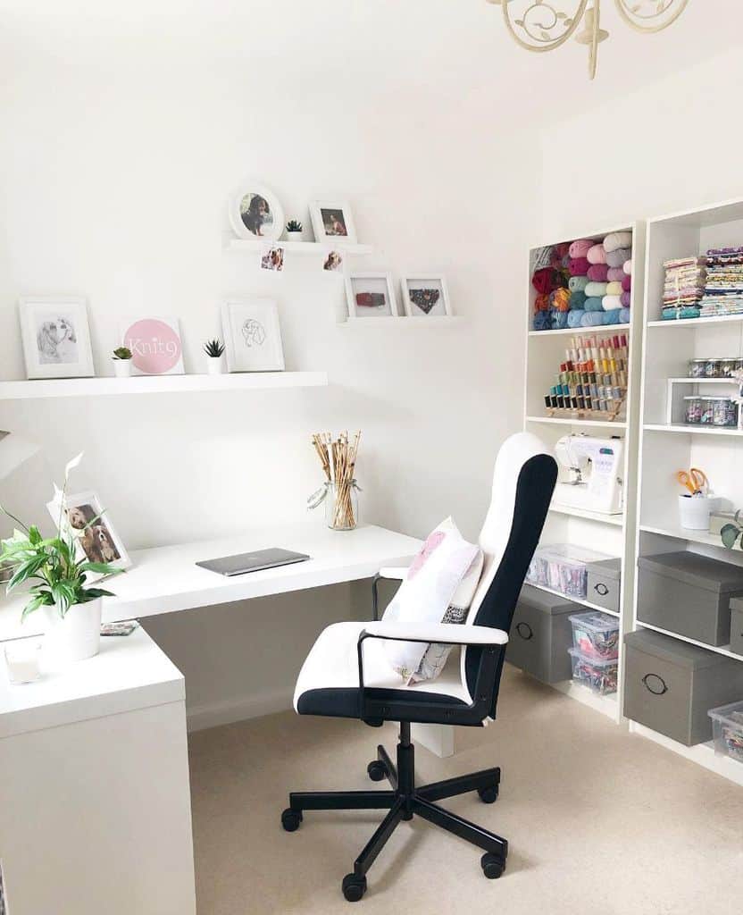 Bright and minimalist sewing room with organized shelves, yarn storage, a sleek desk, and decorative wall accents