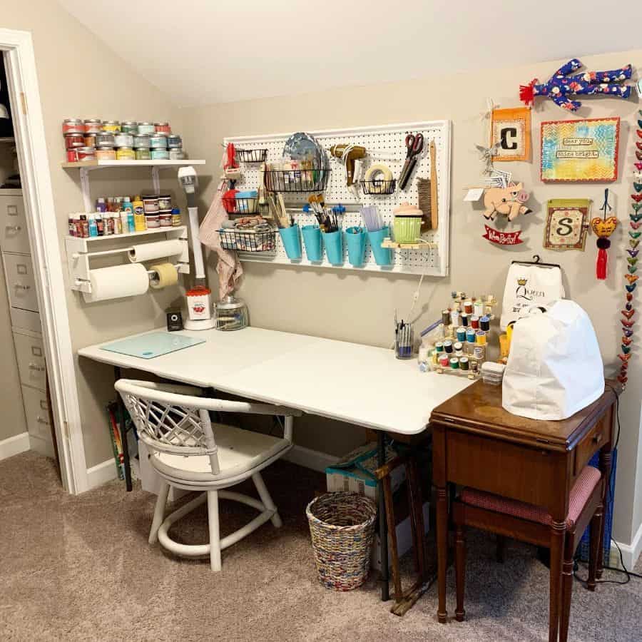 Crafting workspace with a pegboard for tools, organized shelves for supplies, and a large table for creative projects