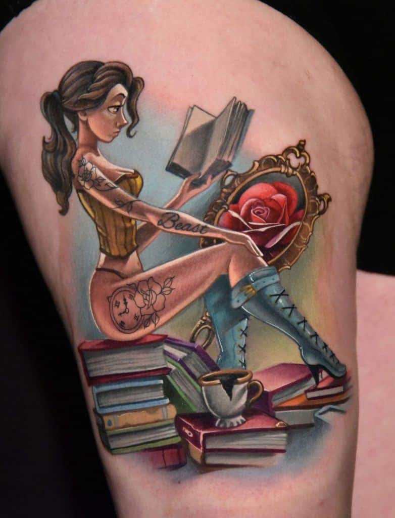 Stylized tattoo of a modernized Belle sitting on a stack of books, reading, with a 'Beast' tattoo on her arm, an enchanted rose, and Chip nearby.