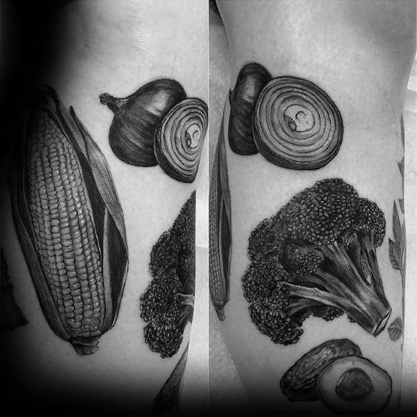 Black and gray realistic vegetable tattoo featuring broccoli, corn, onion, and avocado, with intricate shading for a bold and detailed design.