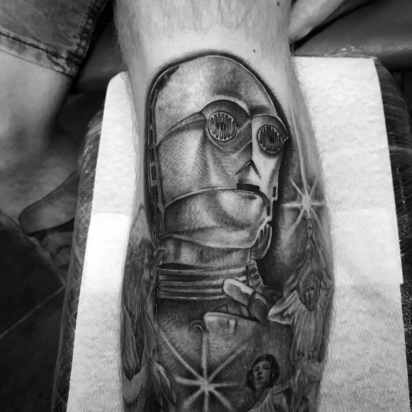 Black and grey Star Wars tattoo featuring C-3PO with realistic shading, Princess Leia, and star accents, creating a classic cinematic design.