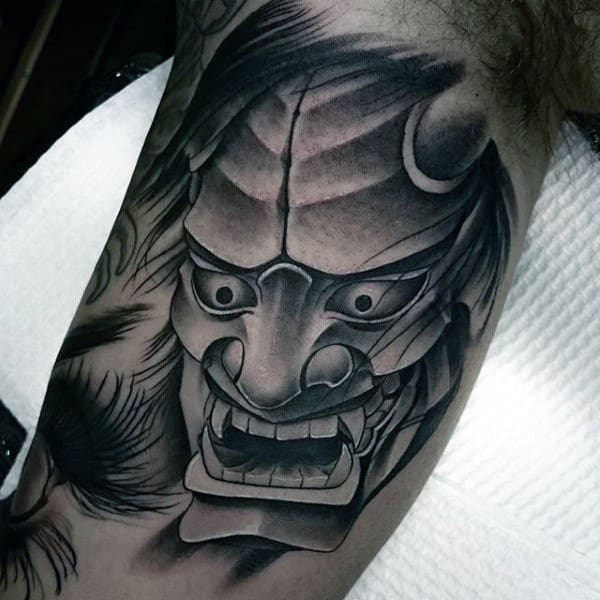 Shaded Black And Grey Hannya Mask Bicep Tattoo On Man