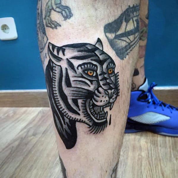 Shaded Black And Grey Tiger With Orange Eyes Mens Traditional Leg Tattoo