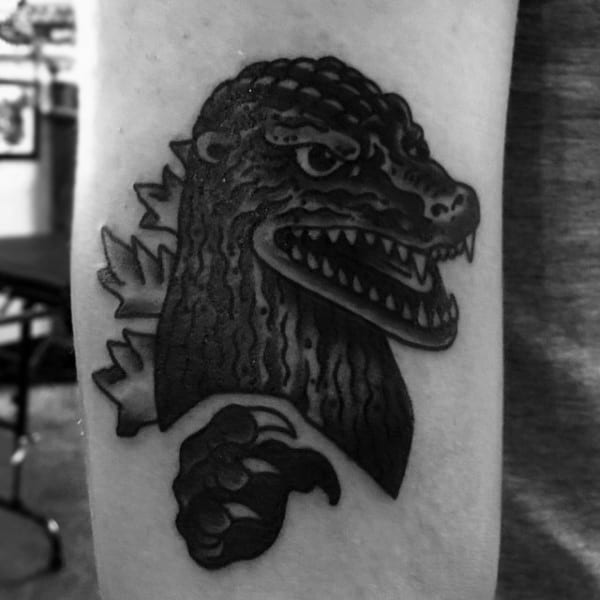 Shaded Black Tattoo Of Godzilla On Guy