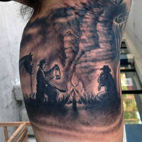 Shaded Blackwork Tattoo Of Western Men By Fire With Horse On Guy