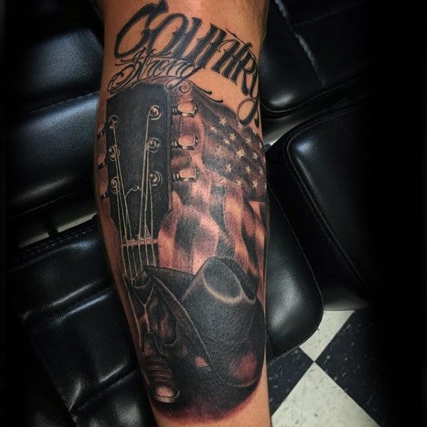 Shaded Country Guitar American Flag Cowboy Hat Tattoo On Guy