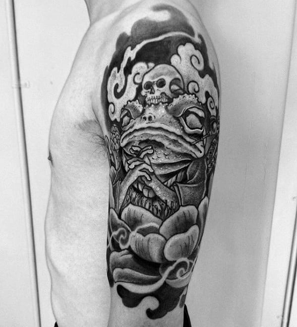 A black and gray tattoo featuring Gamabunta, the toad boss from Naruto, depicted in a traditional Japanese style with skulls and swirling clouds