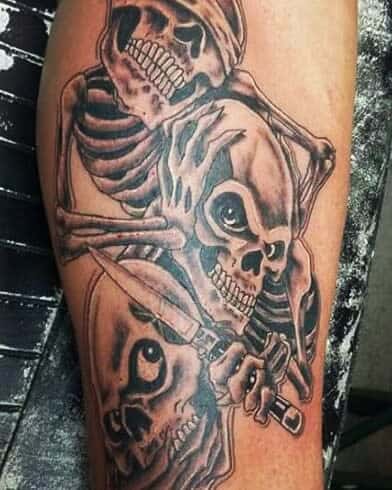 Detailed tattoo of three skeletons intertwined, each representing 'Hear No Evil, See No Evil, Speak No Evil,' featuring dark shading and bold lines