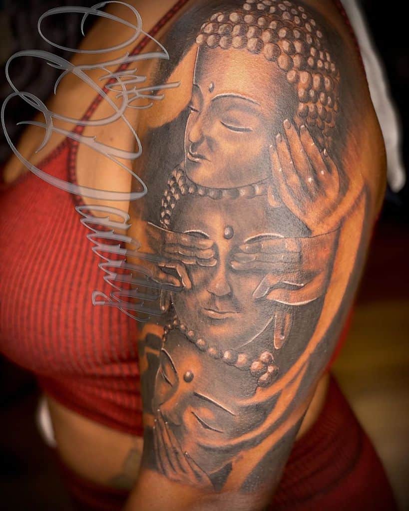 Tattoo of three Buddha faces with hands covering eyes, ears, and mouth on an arm