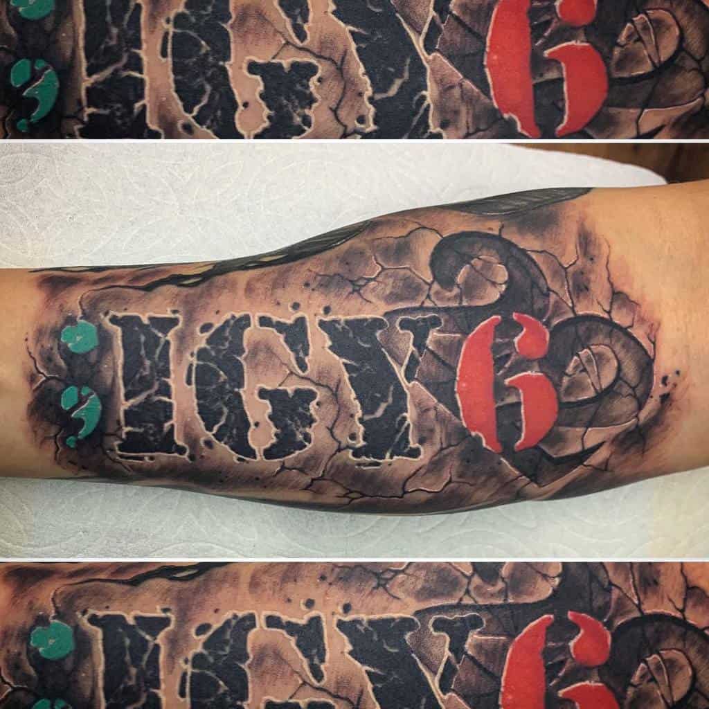 Forearm tattoo featuring ';IGY6' in bold black lettering with a cracked stone effect, a red 6, and a green semicolon symbolizing resilience