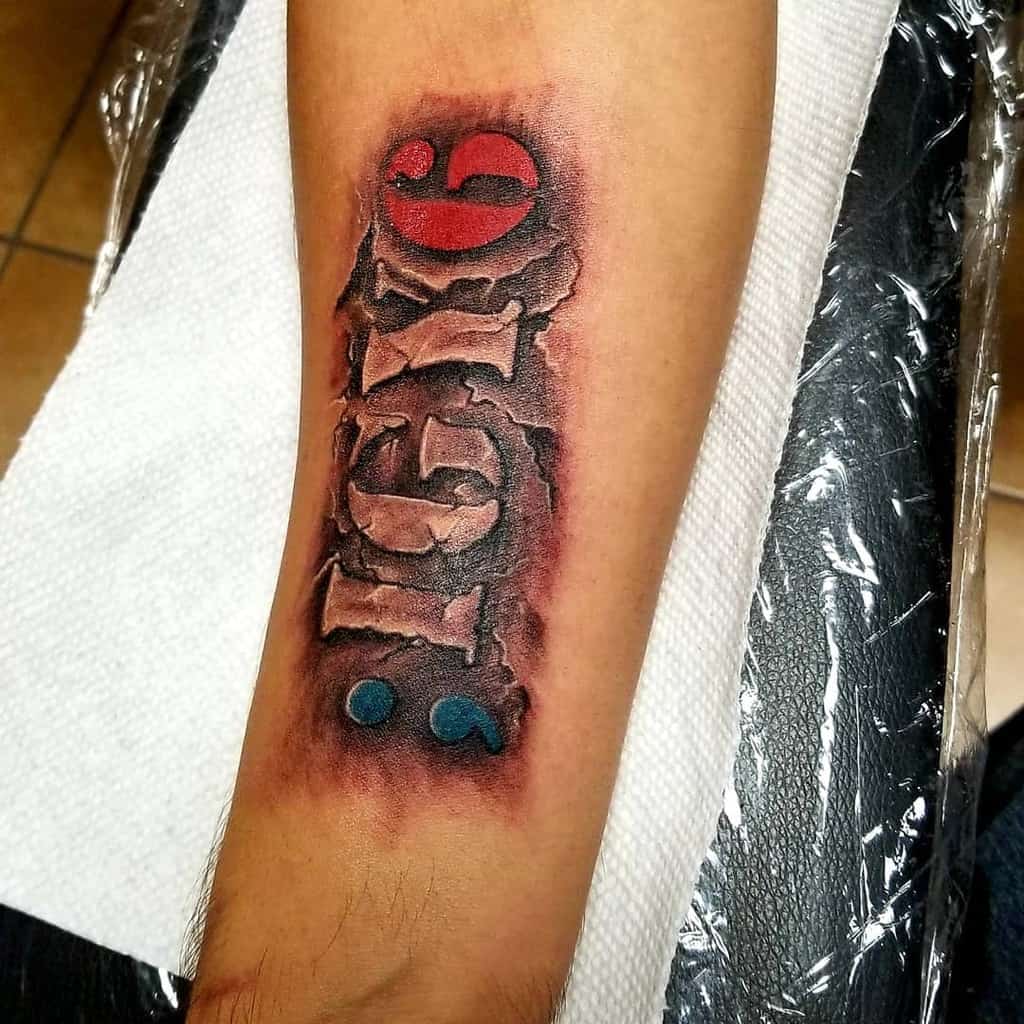 Forearm tattoo of ';IGY6' with a bold 3D effect, red 6, and blue semicolon, surrounded by a torn skin illusion