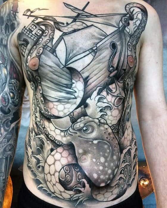 Japanese chest tattoo featuring a shaded octopus entangling a sailing ship, with intricate wave and tentacle details