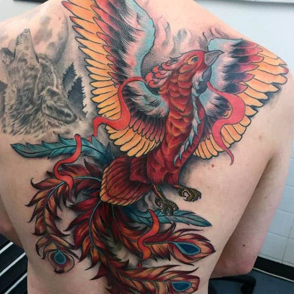 A vibrant phoenix tattoo with open wings covering a man's back