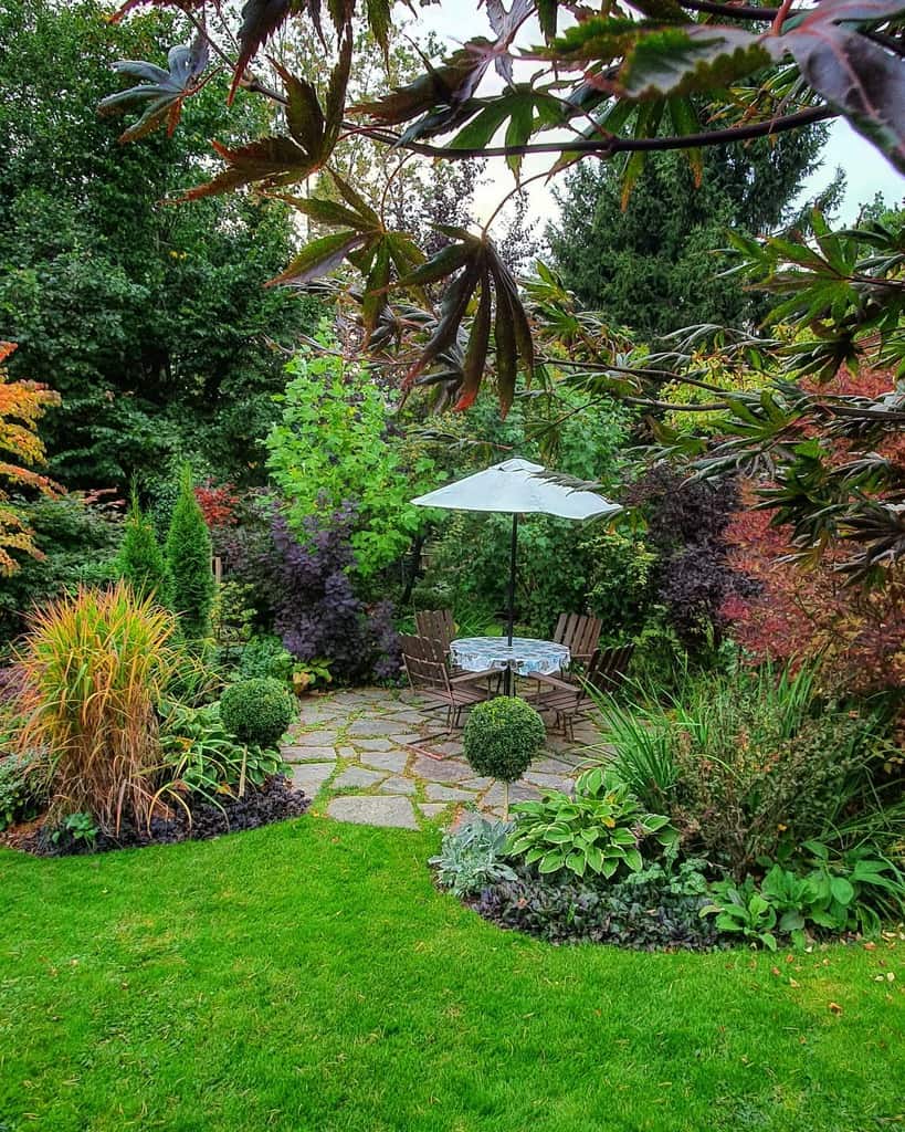 shaded paver patio in lush garden 