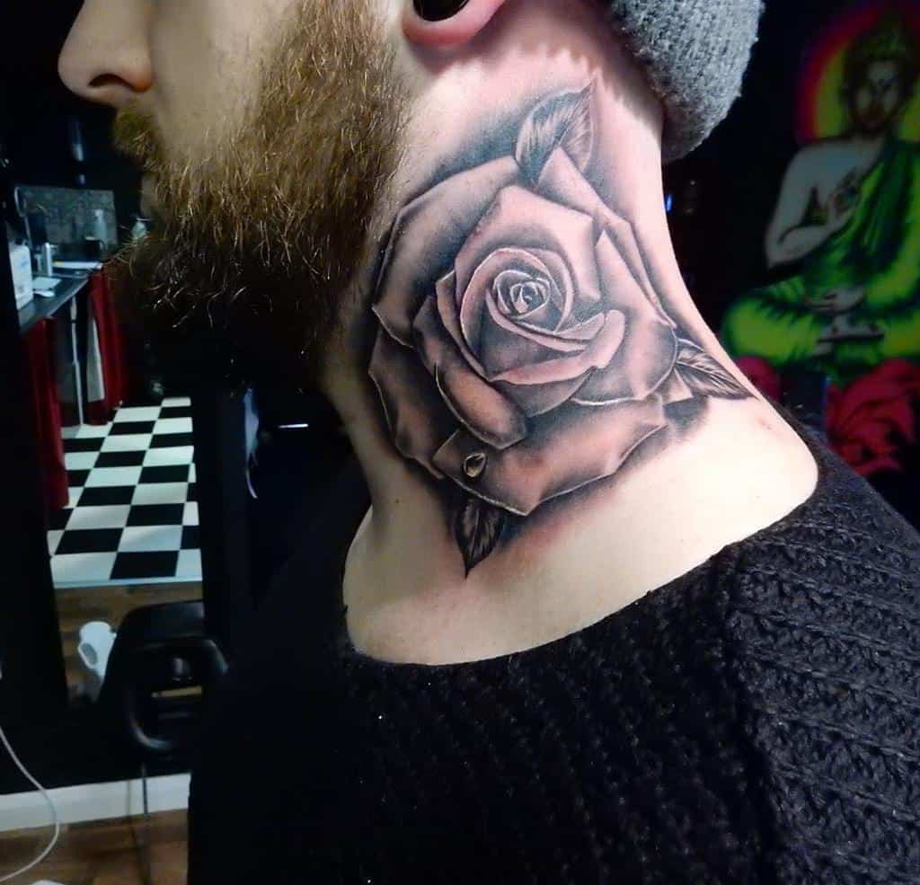 Black and grey shaded rose tattoo on the side of the neck, featuring bold petals, detailed leaves, and subtle highlights