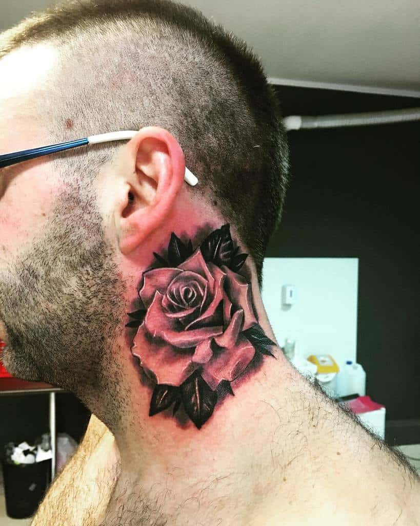 A man proudly sports a large rose tattoo that elegantly adorns his neck