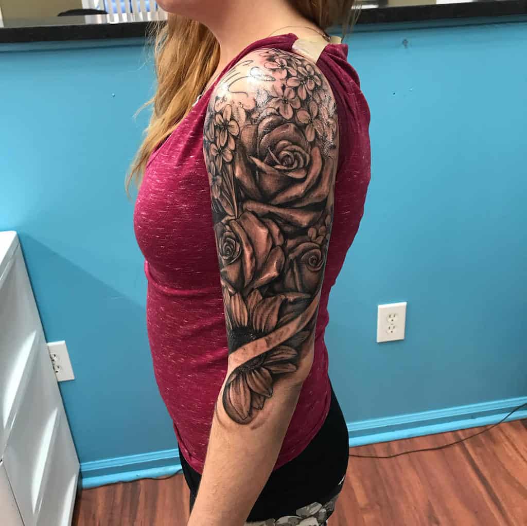 Woman with a floral sleeve tattoo on arm