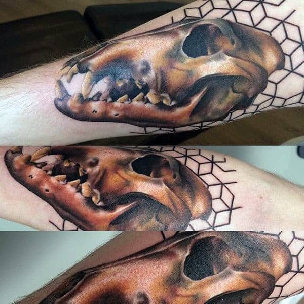 Wolf skull tattoo with a geometric background on the forearm