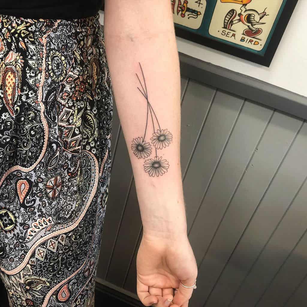 Forearm tattoo black and grey shading daisy bouquet