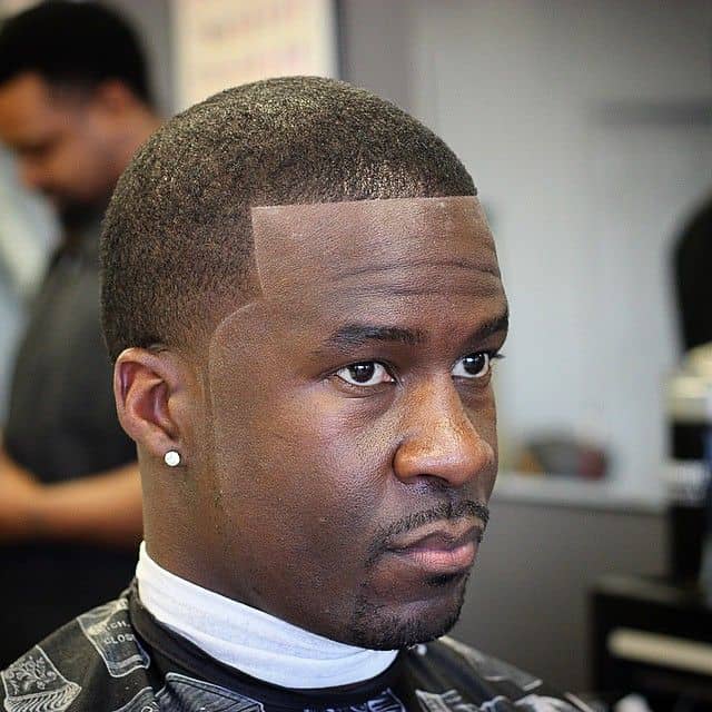 Wavy haircut with barely visible fade and a clean cut hairline