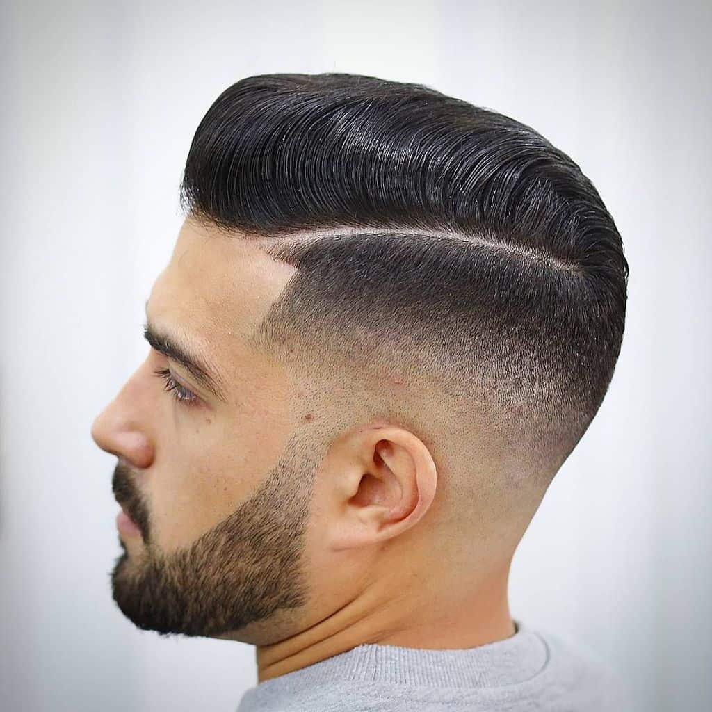 A pompadour fade with a clean line and faded sides