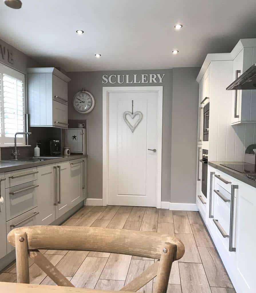 large shaker galley kitchen white cabinets gray walls