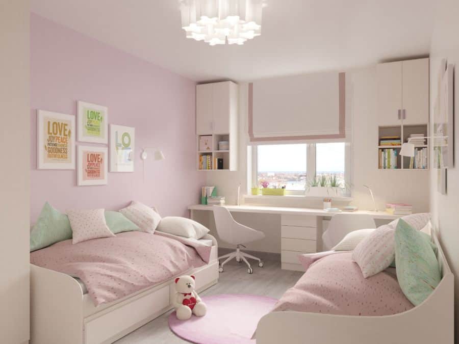 girls bedroom with twin beds and white wall shelves and work desk