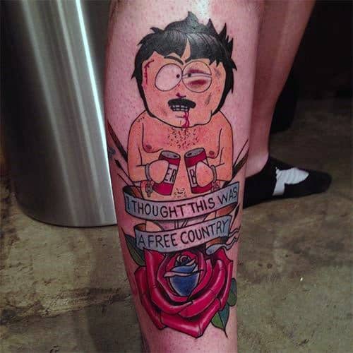 South Park tattoo of Randy Marsh holding beer cans, with a banner reading 'I Thought This Was a Free Country,' featuring bold colors and a rose.