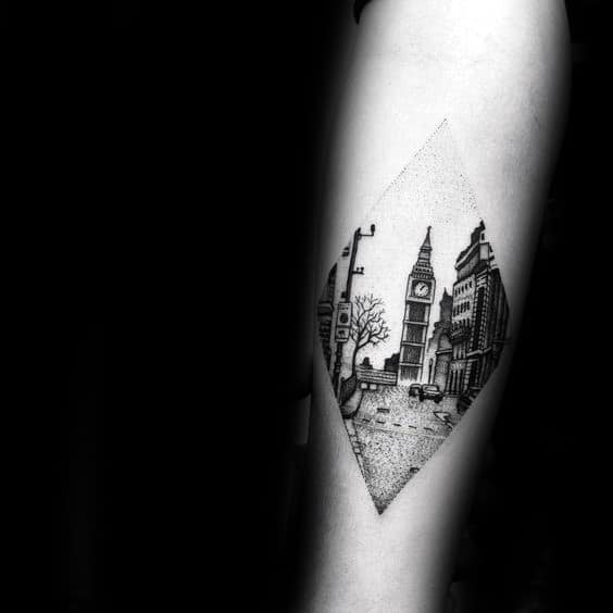 Detailed black and grey tattoo in a diamond shape, featuring Big Ben and a cityscape with a vintage, minimalistic style.