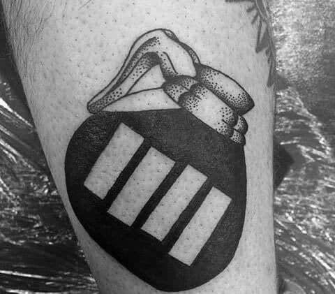 Tattoo of a hand clutching a grenade with Black Flag bars as vents, merging punk aggression with explosive visual symbolism.
