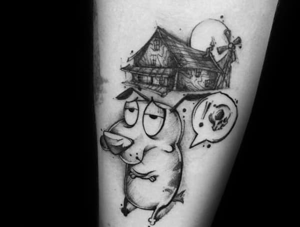 Black and grey tattoo of Courage the Cowardly Dog with a sarcastic expression, his haunted house above, and a speech bubble with a skull.