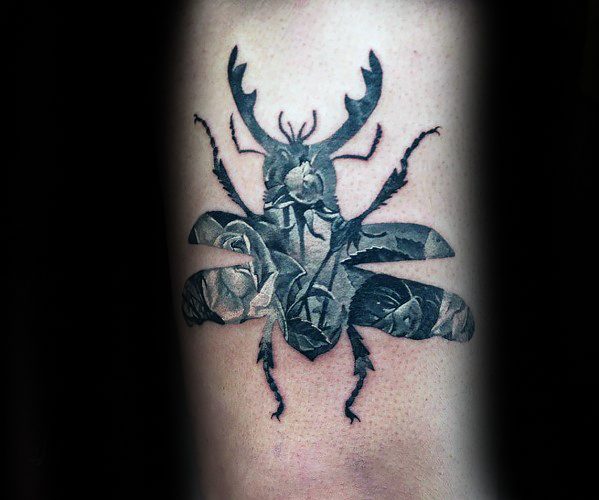 Black and grey tattoo of a beetle silhouette filled with realistic roses and a pocket watch, blending nature, time, and symbolism.