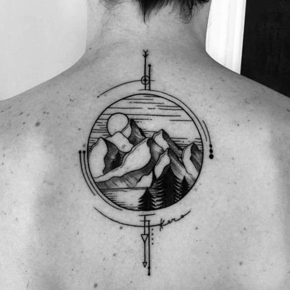 Circular mountain landscape tattoo on the upper back with trees, sun, and abstract geometric lines, featuring a small signature below.