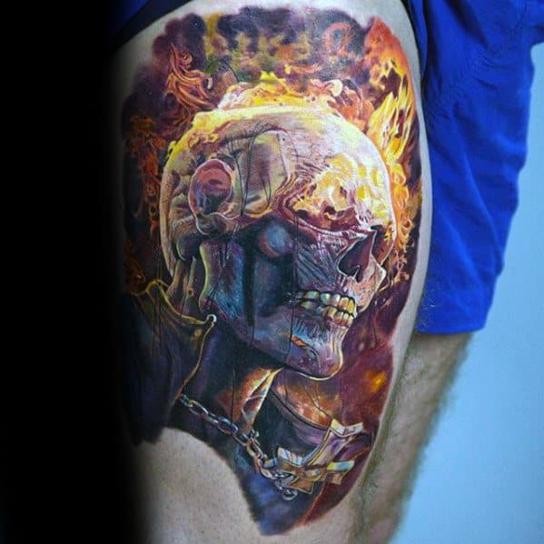 Hyper-realistic Ghost Rider thigh tattoo with a flaming skull, glowing fire effects, and metallic chain wrapping around the neck and chest.