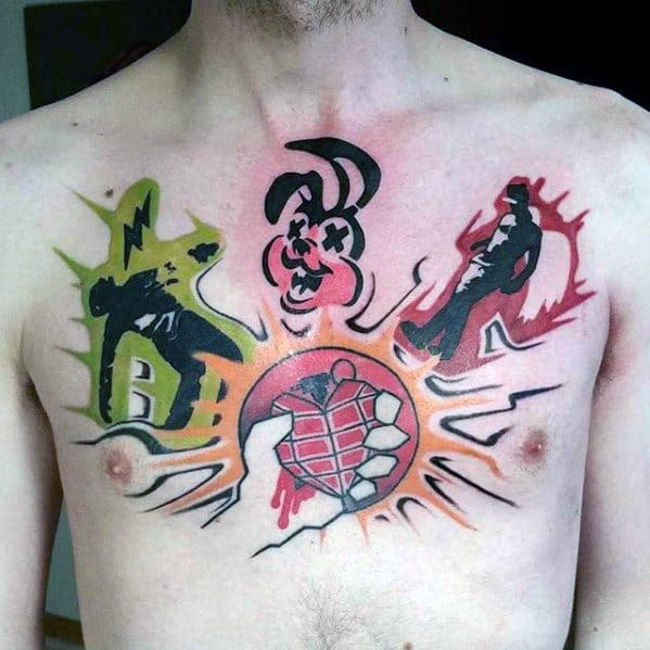 Colorful chest tattoo combining Green Day symbols: the hand grenade heart, punk bunny, electrified figure, and silhouettes from *American Idiot*.