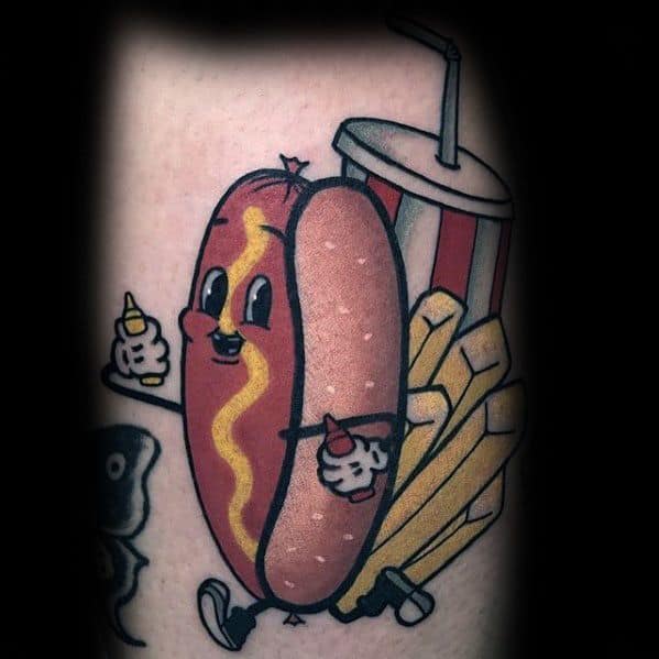 Tattoo of a cartoon-style hot dog holding ice cream, a drink, and French fries, with a happy expression, on the upper arm.
