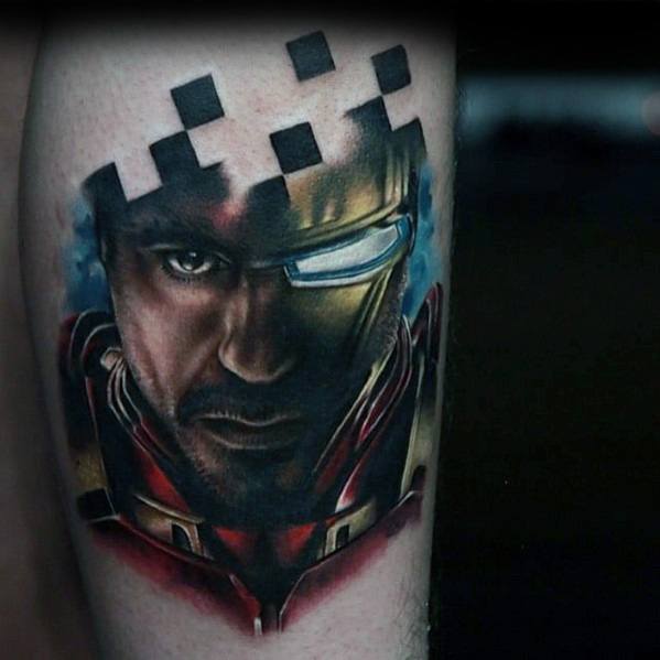 Iron Man tattoo featuring a stunning portrait of Tony Stark with his helmet and arc reactor, blending realistic details with a creative pixelated effect around his head.
