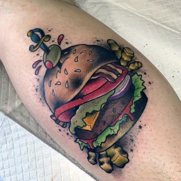 Cartoon-style cheeseburger tattoo with a sword through it, condiments spilling out