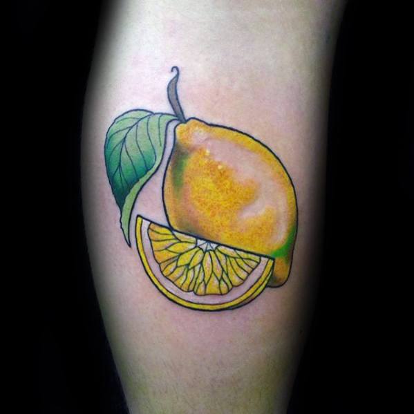 Bright and colorful tattoo of a lemon with a detailed lemon slice and green leaf, featuring smooth gradients and bold outlines.
