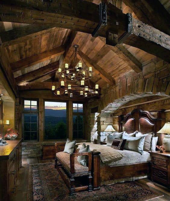 Rustic bedroom with a vaulted ceiling and warm wooden tones.