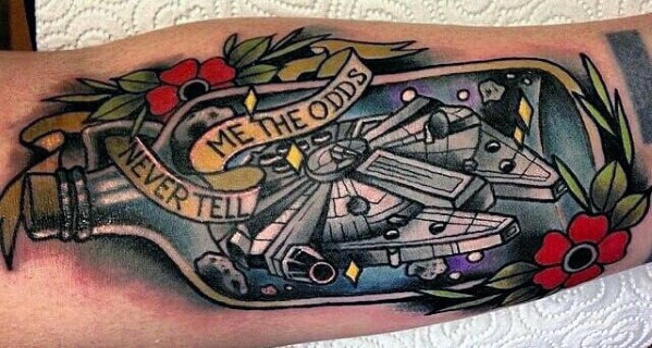 Traditional-style Millennium Falcon tattoo in a bottle with flowers and the quote "Never Tell Me The Odds" wrapped in a banner.