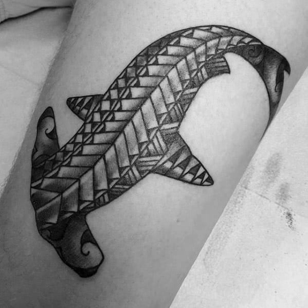 Polynesian hammerhead shark tattoo with bold triangular tribal patterns symbolizing power, protection, and connection to the sea.
