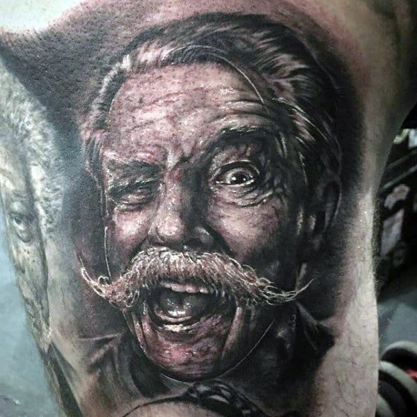 Realistic tattoo of an older man with a mustache, winking and smiling in a humorous expression