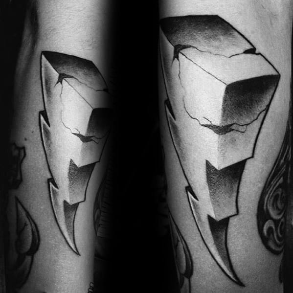 Bold black and grey Power Rangers lightning bolt tattoo with a cracked stone texture and dramatic shadowing for a rugged 3D effect.