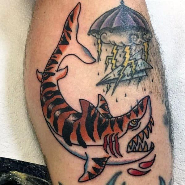Traditional tiger shark tattoo with bold orange stripes, sharp teeth, blood drops, and a stormy umbrella with lightning overhead.